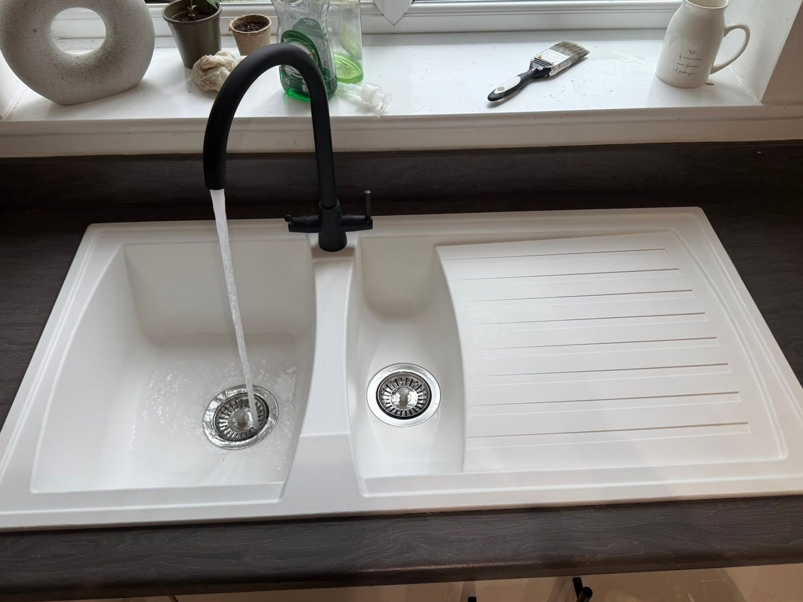 New white ceramic sink with black mixer tap fitted by Jacob Conway Plumbing Services